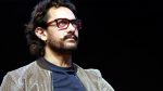 Aamir Khan smiling in a casual outfit.