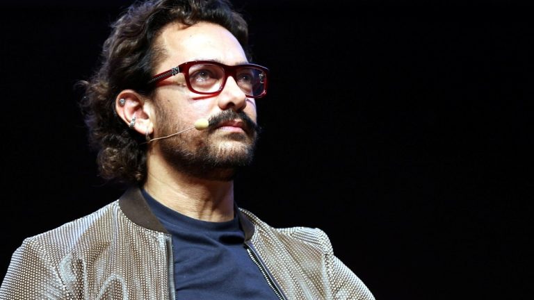 Aamir Khan smiling in a casual outfit.